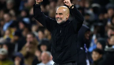 Manchester City's Spanish manager Pep Guardiola celebrates as Manchester City's Brazilian midfielder #26 Savinho scores the team's third goal during the English Premier League football match between Manchester City and Crystal Palace at the Etihad Stadium in Manchester, north west England, on May 13, 2026. (Photo by Darren Staples/AFP)/RESTRICTED TO EDITORIAL USE. No use with unauthorized audio, video, data, fixture lists, club/league logos or 'live' services. Online in-match use limited to 120 images. An additional 40 images may be used in extra time. No video emulation. Social media in-match use limited to 120 images. An additional 40 images may be used in extra time. No use in betting publications, games or single club/league/player publications./