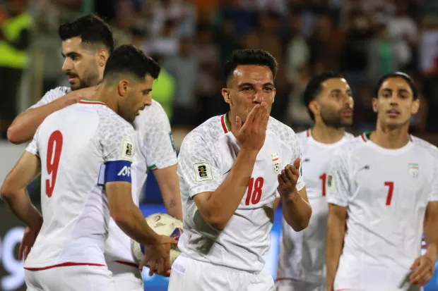 (FILES) Iran's midfielder #18 Amirhossein Hosseinzadeh celebrates scoring his team's third goal during the FIFA World Cup 2026 Asia zone qualifiers group A football match between Iran and the North Korea at the Azadi Sports Complex in Tehran on June 10, 2025. After days of strikes on sites all over Iran, and Tehran's military lashing out at US targets and allies in the Gulf, Iran's participation in the 2026 World Cup is in serious doubt. (Photo by ATTA KENARE/AFP)