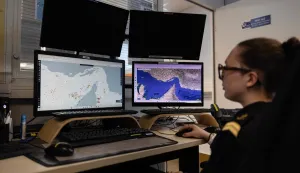 A worker of the Maritime International Cooperation and Awareness (MICA) center looks at screens at the MICA in Brest, western France on April 27, 2026. Attacks on oil tankers in the Strait of Hormuz, piracy off the coast of Somalia, drug trafficking: with their eyes fixed on screens crammed with maps, a dozen sailors at the MICA Centre monitor the world?s maritime hotspots in real time.Since the start of the war in the Middle East, triggered by Israeli-American strikes on Iran on February 28, 2026, this French centre of expertise in maritime security, attached to the French Navy, has been providing invaluable support to civilian vessels and crews stranded in the Persian Gulf. (Photo by Fred TANNEAU/AFP)