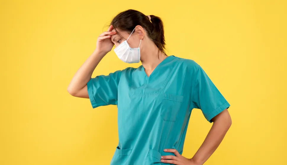 front view female doctor in medical shirt and mask on yellow background medic pandemic health covid- hospital color