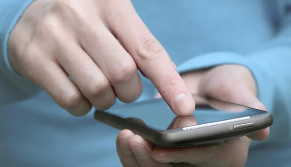 hand holding smartphone and finger tapping on the screen