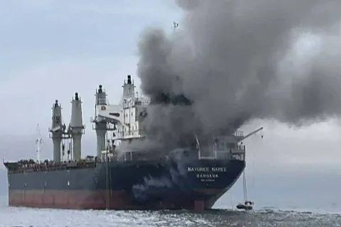 This handout photo taken on March 11, 2026 and released by the Royal Thai Navy shows smoke rising from the Thai bulk carrier 'Mayuree Naree' near the Strait of Hormuz after an attack. A Thai bulk carrier travelling in the crucial Strait of Hormuz was attacked March 11, with 20 crew members rescued so far, the Thai navy said. (Photo by Handout/ROYAL THAI NAVY/AFP)/-----EDITORS NOTE --- RESTRICTED TO EDITORIAL USE - MANDATORY CREDIT "AFP PHOTO/ROYAL THAI NAVY " - NO MARKETING - NO ADVERTISING CAMPAIGNS - DISTRIBUTED AS A SERVICE TO CLIENTS -