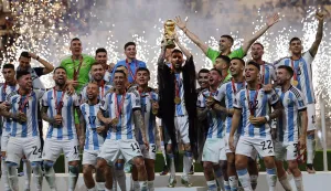 epa10373020 Lionel Messi (C) of Argentina lifts the trophy as his teammates celebrate after winning the FIFA World Cup 2022 Final between Argentina and France at Lusail stadium, Lusail, Qatar, 18 December 2022. Argentina won 4-2 on penalties. EPA/Ronald Wittek