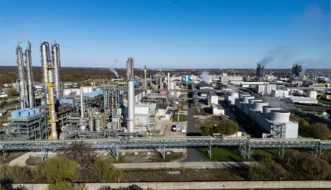An aerial view shows the SKW Piesteritz agro-chemical plant in Piesteritz near Wittenberg, northern Germany, on April 9, 2026. As the effective closure of the Strait of Hormuz continues to roil the global economy, one German town has been scrambling to help make up the shortfall in essential supplies of fertilisers. Wittenberg, better known to many as a cradle of the Protestant Reformation, is also home to a chemical plant founded in 1915, in the midst of World War One. At SKW's sprawling 220-hectare site, a 23-kilometer rail transports urea, ammonia and finished fertilisers, destined for sites across Germany and also elsewhere in Europe. SKW is Germany's largest producer of urea, an essential component of fertilisers. The plant has been running at full capacity to try to make up the shortfall in supply from the Hormuz blockade. (Photo by John MACDOUGALL/AFP)