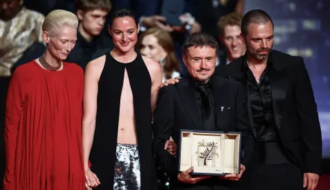 Director Cristian Mungiu, Palme d'Or award winner for the film "Fjord", next to cast members Renate Reinsve and Sebastian Stan and Tilda Swinton, on stage during the closing ceremony of the 79th Cannes Film Festival in Cannes, France, May 23, 2026. REUTERS/Sarah Meyssonnier Photo: Sarah Meyssonnier/REUTERS