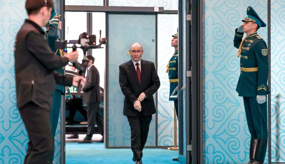 In this pool photograph distributed by the Russian state agency Sputnik Russian President Vladimir Putin walks at the Palace of Independence during his state visit to Kazakhstan in Astana on May 29, 2026. (Photo by Alexander KAZAKOV/POOL/AFP)