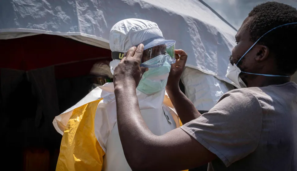 Doctors Without Border (MSF) personnel at the Elikya clinic Ebola treatment center is helped to wear the personal protection equipment (PPE) as he prepares to enter the hospital rooms for Ebola patients in Bunia, in the eastern Democratic Republic of the Congo, on June 5, 2026. (Photo by GLODY MURHABAZI/AFP)