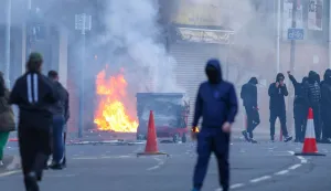 A building is set alight in the Sandy Row area of Belfast city centre, Northern Ireland, in the evening of June 9, 2026. Northern Ireland police appealed for calm Tuesday after a stabbing in Belfast allegedly by a Sudanese suspect and captured in a graphic video prompted calls for anti-immigration protests from UK far-right figures. (Photo by Paul Faith/AFP)