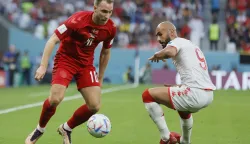 epa10320406 Christian Eriksen (L) of Denmark in action against Issam Jebali of Tunisia during the FIFA World Cup 2022 group D soccer match between Denmark and Tunisia at Education City Stadium in Doha, Qatar, 22 November 2022. EPA/Ronald Wittek