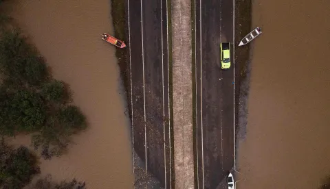 (FILES) Ariel view showing the flooded ERS-448 road in Canoas, Rio Grande do Sul state, Brazil, on May 13, 2024. In 2024 around two million people have been affected, more than 600,000 of whom were forced from their homes due to the disaster, which experts attribute to climate change and the El Nino weather phenomenon. In 2026 there is an 80-percent chance of the warming El Nino phenomenon developing between June and August, increasing the risk of extreme weather events, the World Meteorological Organization said on June 2, 2026. (Photo by Nelson ALMEIDA/AFP)
