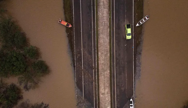 (FILES) Ariel view showing the flooded ERS-448 road in Canoas, Rio Grande do Sul state, Brazil, on May 13, 2024. In 2024 around two million people have been affected, more than 600,000 of whom were forced from their homes due to the disaster, which experts attribute to climate change and the El Nino weather phenomenon. In 2026 there is an 80-percent chance of the warming El Nino phenomenon developing between June and August, increasing the risk of extreme weather events, the World Meteorological Organization said on June 2, 2026. (Photo by Nelson ALMEIDA/AFP)