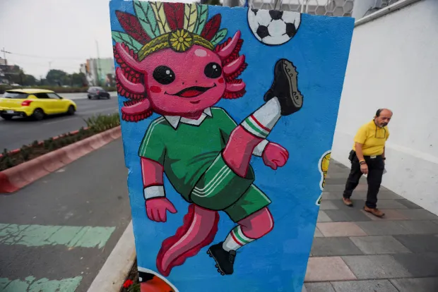 A man walks near a wall featuring an image of the critically endangered axolotl, a salamander native to central Mexico's lakes, as its use in public imagery ahead of the FIFA World Cup 2026 has divided residents who say more should be done to protect its habitat, in Mexico City, Mexico, June 3, 2026. REUTERS/Quetzalli Nicte-Ha Photo: QUETZALLI NICTE-HA/REUTERS
