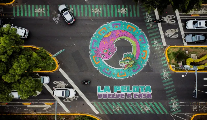 A drone view shows an intersection painted with the phrase "La pelota vuelve a casa" ("The ball returns home") alongside an image of the critically endangered axolotl, a salamander native to central Mexico's lakes, as its use in public imagery ahead of the FIFA World Cup 2026 has divided residents who say more should be done to protect its habitat, in Mexico City, Mexico, May 27, 2026. REUTERS/Raquel Cunha Photo: Raquel CUNHA/REUTERS