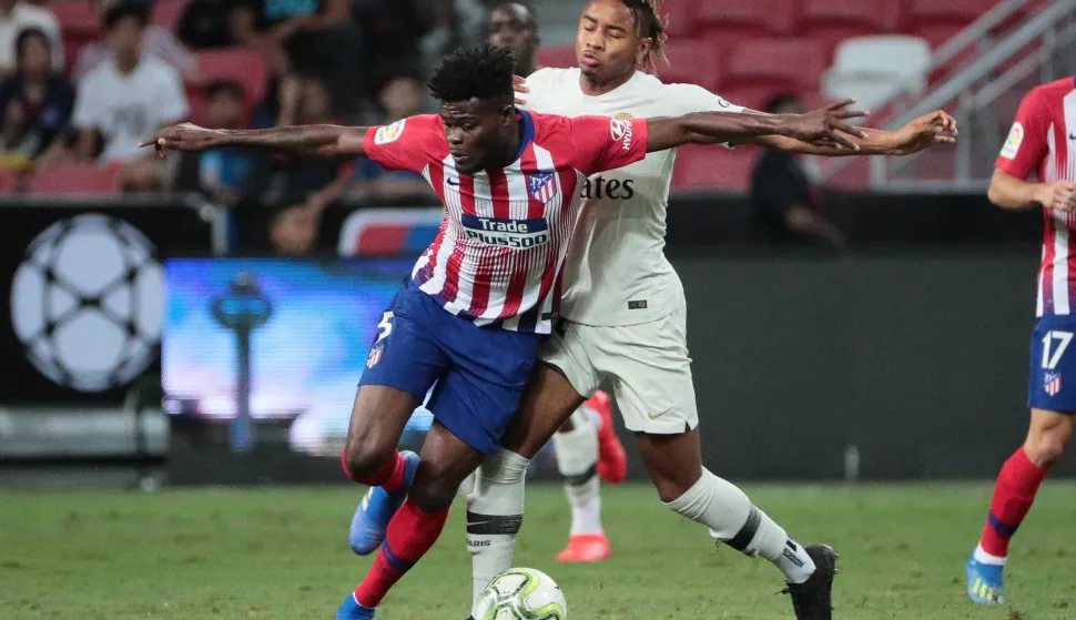 epa06918916 Atletico de Madrid's Thomas Partey (L) in action against Paris Saint-Germain's Christopher Nkunku (R) during the International Champions Cup match between Atletico de Madrid and Paris Saint-Germain at the National Stadium in Singapore, 30 July 2018. EPA/WALLACE WOON