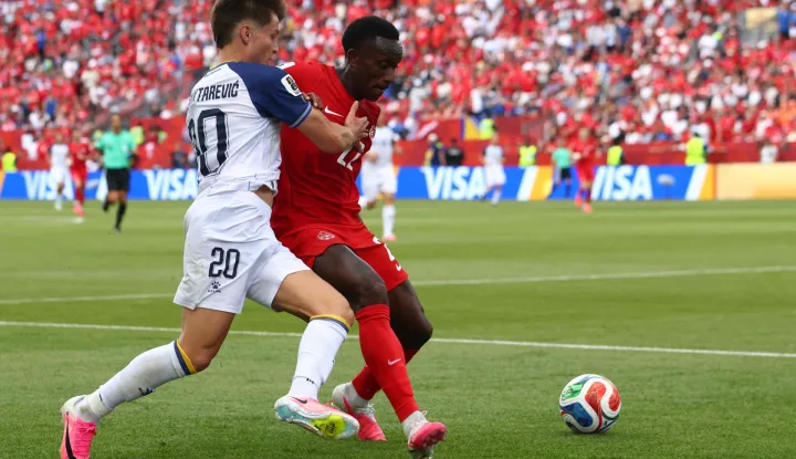 Bosnia-Herzegovina's forward #20 Esmir Bajraktarevic (L) fights for the ball with Canada's defender #22 Richie Laryea during the 2026 World Cup Group B football match between Canada and Bosnia and Herzegovina at the Toronto Stadium in Toronto on June 12, 2026. (Photo by Cole Burston/AFP)