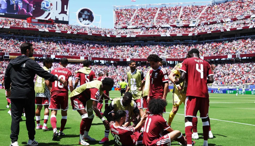 SANTA CLARA, CALIFORNIA - JUNE 13: Boualem Khoukhi #16 of Qatar celebrates with teammates after scoring the team's first goal during the FIFA World Cup 2026 Group B match between Qatar and Switzerland at San Francisco Bay Area Stadium on June 13, 2026 in Santa Clara, California. Emilee Chinn/Getty Images/AFP (Photo by Emilee Chinn/GETTY IMAGES NORTH AMERICA/Getty Images via AFP)