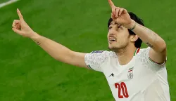 (FILES) Iran's forward #20 Sardar Azmoun celebrates after scoring his team's first goal during the Qatar 2023 AFC Asian Cup semi-final football match between Iran and Qatar at al-Thumama Stadium in Doha on February 7, 2024. Azmoun, the third-highest scorer in the history of the Iranian national team, is not among the players selected for the World Cup, according to a list published June 1, 2026, by the country's football federation. (Photo by KARIM JAAFAR/AFP)