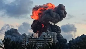 (FILES) A fireball and smoke erupt from a building following an Israeli strike in Tyre, southern Lebanon, on May 28, 2026. The world has settled in a high level of violence with, in 2025, the largest number of state conflicts since the end of World War II and an explosion of attacks directly targeting civilians, according to the annual PRIO Global Conflict Trends report on the trend of conflicts in the world published on June 9, 2026. (Photo by KAWANT HAJU/AFP)
