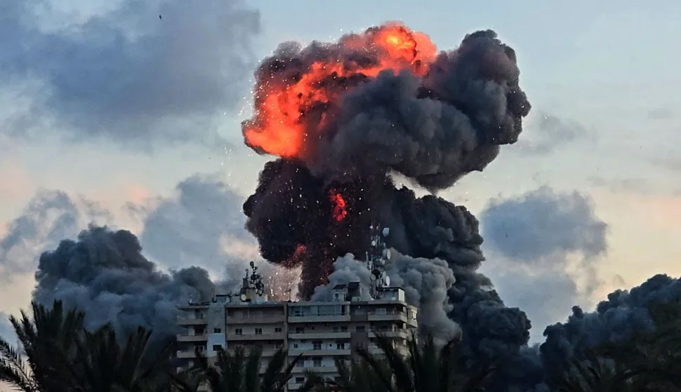(FILES) A fireball and smoke erupt from a building following an Israeli strike in Tyre, southern Lebanon, on May 28, 2026. The world has settled in a high level of violence with, in 2025, the largest number of state conflicts since the end of World War II and an explosion of attacks directly targeting civilians, according to the annual PRIO Global Conflict Trends report on the trend of conflicts in the world published on June 9, 2026. (Photo by KAWANT HAJU/AFP)