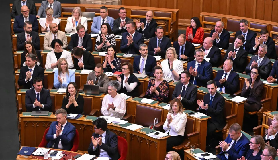 Lawmakers react after voting on an amendment to the constitution by introducing term-limits for prime ministers to a maximum of eight years in office, in the main hall of the Parliament building in Budapest, on June 15, 2026. Hungarian lawmakers on June 15 voted overwhelmingly to limit prime ministers' terms in office to a maximum of eight years, a constitutional change that blocks nationalist Viktor Orban's return. (Photo by Attila KISBENEDEK/AFP)