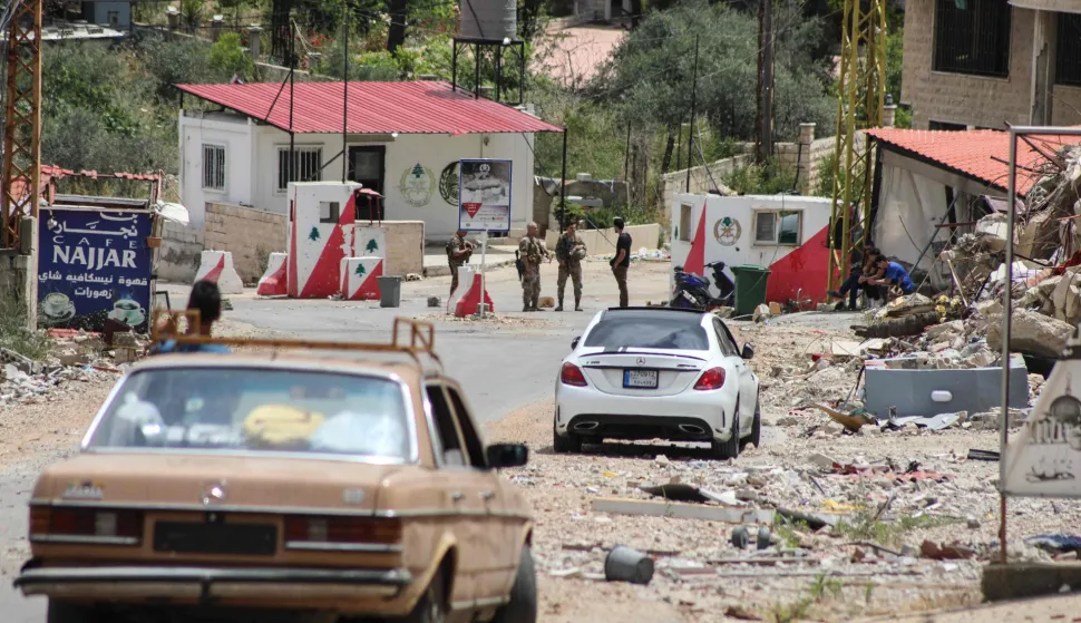 Lebanese soldiers set up a checkpoint in the southern village of Kafra, closing the road leading to the nearby village of Haris, where the Israeli military remains present, on June 15, 2026. Israel's defence minister said on June 15, that Israeli forces would remain in Lebanon, Syria and Gaza indefinitely, hours after the United States and Iran agreed to end the Middle East war, including in Lebanon. (Photo by Kawnat HAJU/AFP)/