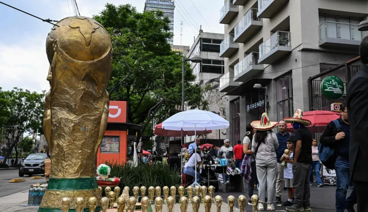 Street vendors display souvenirs shaped like the FIFA World Cup trophy on a street in Mexico City on June 8, 2026. (Photo by Yuri CORTEZ/AFP)