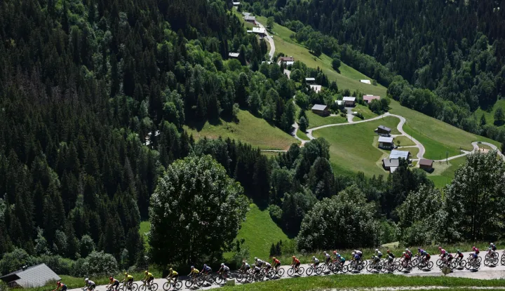 The pack of riders (peloton) cycles in the ascent of Col du Pre during the 8th and final stage of the Tour Auvergne-Rhone-Alpes cycling race (formerly known as the Criterium du Dauphine), 120,1km between Beaufort and Plateau de Solaison, in the French Alps on June 14, 2026. (Photo by Anne-Christine POUJOULAT/AFP)