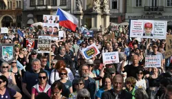 Several hundred people holding placards gather for a protest march to express support for public service media on April 22, 2026, in Prague, Czech Republic. Placard reads "Czech prime Minister Andrej Babis wants to control the media" (Photo by Michal Cizek/AFP)