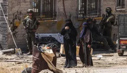 TOPSHOT - Israeli soldiers stand by as Palestinian women look on as Israeli bulldozers demolish a Palestinian home, which the Israeli authorities say was built without permission, in Ar-Rifaiyya village, south of the Israeli-occupied Palestinian West Bank city of Hebron on June 17, 2026. Israel, whose army has occupied the West Bank since 1967, demolishes the homes of Palestinians which it says have been built without a permit. (Photo by HAZEM BADER/AFP)/