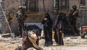 TOPSHOT - Israeli soldiers stand by as Palestinian women look on as Israeli bulldozers demolish a Palestinian home, which the Israeli authorities say was built without permission, in Ar-Rifaiyya village, south of the Israeli-occupied Palestinian West Bank city of Hebron on June 17, 2026. Israel, whose army has occupied the West Bank since 1967, demolishes the homes of Palestinians which it says have been built without a permit. (Photo by HAZEM BADER/AFP)/