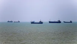 TOPSHOT - In this picture obtained from Iran's ISNA news agency on June 18, 2026, vessels are seen anchored in Bandar Abbas along the Strait of Hormuz. Oil prices tumbled after Trump and his Iranian counterpart separately signed their accord to end the Middle East war, with the Strait of Hormuz to reopen but two months of negotiations lying ahead. (Photo by AMIRHOSSEIN KHORGOOEI/ISNA/AFP)/