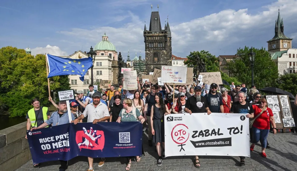 Protesters holds a banner reading 'Just give up Czech Minister of Culture Oto Klempir' during a demonstration supporting public service media on May 24, 2026, in Prague, Czech Republic. A draft bill, which includes abolishing TV and radio license fees and has been criticized by the opposition and some experts would shift funding for CT (Czech Television) and CRo (Czech Radio) from license fees to the state budget. (Photo by Michal Cizek/AFP)