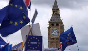 EU flags are waved beside The Elizabeth Tower commonly known by the name of the clock's bell "Big Ben, "during a National 'Rejoin the EU' march in central London on June 20, 2026. (Photo by CARLOS JASSO/AFP)