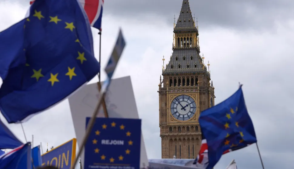 EU flags are waved beside The Elizabeth Tower commonly known by the name of the clock's bell "Big Ben, "during a National 'Rejoin the EU' march in central London on June 20, 2026. (Photo by CARLOS JASSO/AFP)