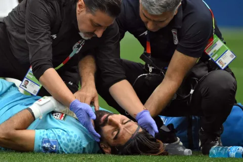 Iran's goalkeeper #01 Alireza Beiranvand receives medical attention during the 2026 World Cup Group G football match between Belgium and Iran at the Los Angeles Stadium in Inglewood on June 21, 2026. (Photo by Patrick T. Fallon/AFP)