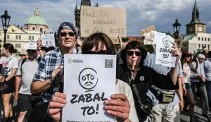 A protester holds a sign reading 'Just give up Czech Minister of Culture Oto Klempir' during a demonstration supporting public service media on May 24, 2026, in Prague, Czech Republic. A draft bill, which includes abolishing TV and radio license fees and has been criticized by the opposition and some experts would shift funding for CT (Czech Television) and CRo (Czech Radio) from license fees to the state budget. (Photo by Michal Cizek/AFP)