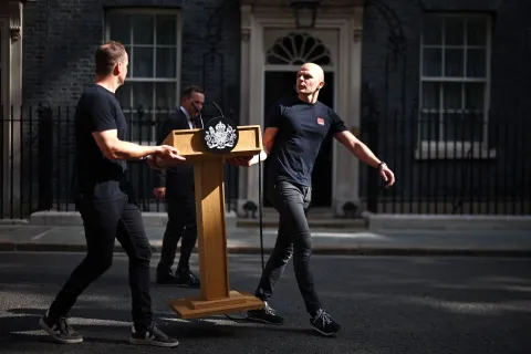 Members of staff bring the lectern outside 10 Downing Street on the morning of June 22, 2026, in London as Britain's Prime Minister Keir Starmer prepares to make a statement on his future. Embattled British Prime Minister Keir Starmer could set out plans to step down as soon as Monday, UK media has reported, the same day his likely successor is expected to be sworn in as a member of parliament. (Photo by Henry Nicholls/AFP)