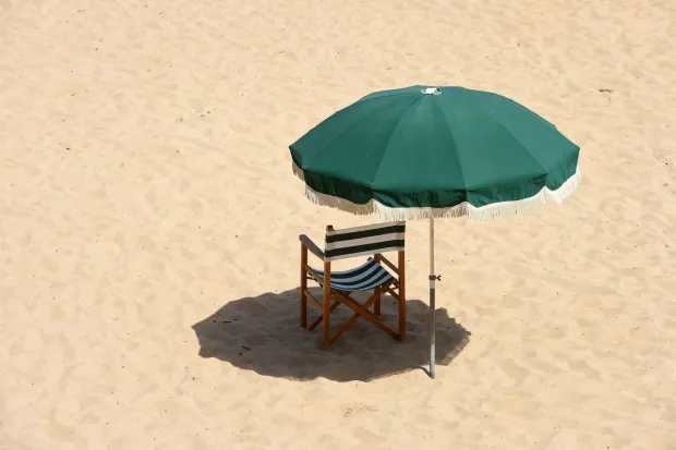 (FILES) An empty deckchair and parasol stand on the sands of Saint-Jean de Luz beach, south-western France, on June 18, 2022, as heatwave conditions sweep across France and western Europe. Scientists warn of record heat, threats to climate monitoring. Planetary heating is intensifying and key climate indicators are deteriorating, top scientists said on June 11, 2026, warning that funding decisions affecting Earth observation systems in the United States and other countries threaten efforts to track global warming. (Photo by GAIZKA IROZ/AFP)