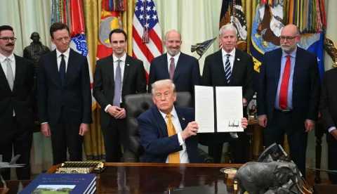 US Secretary of Commerce Howard Lutnick (3R), US Secretary of Energy Chris Wright (2R), Director of the Office of Management and Budget Russell Vought (R) look on as US President Donald Trump holds an executive order about quantumcomputing he just signed in the Oval Office of the White House in Washington, DC, on June 22, 2026. (Photo by Mandel NGAN/AFP)