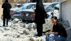 TOPSHOT - A Lebanese woman weeps as she sits on the rubble at the site of an Israeli airstrike that targeted the southern Lebanese village of Qennarit on June 20, 2026. Israel carried out deadly strikes in south Lebanon on June 20, and Hezbollah maintained it had the right to respond, hours after the United States announced a renewed ceasefire in fighting that had strained a fledgling deal with Iran. Lebanon was drawn into the Middle East war on March 2 when Tehran-backed militant group Hezbollah launched attacks on Israel to avenge the killing of the Iranian leader. Israel has responded with broad strikes across Lebanon and a ground offensive. (Photo by AFP)/