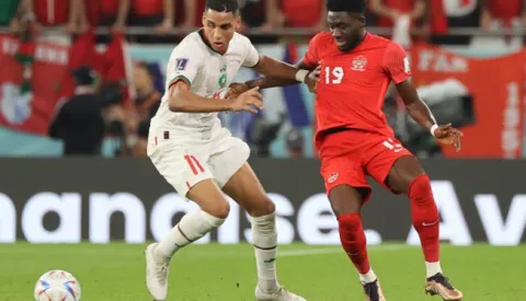 epa10341793 Alphonso Davies (R) of Canada in action against Abdelhamid Sabiri of Morocco during the FIFA World Cup 2022 group F soccer match between Canada and Morocco at Al Thumama Stadium in Doha, Qatar, 01 December 2022. EPA/Mohamed Messara