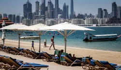 A man walks along the beach at the Anantara The Palm Dubai Resort in Dubai on June 6, 2026. (Photo by FADEL SENNA/AFP)