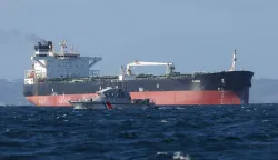 (FILES) A French Navy vessel sails by the Russian oil tanker "Tagor", suspected of flying a false Cameroonian flag and boarded by the French Navy on May 31, 2026, as it arrives in Douarnenez Bay, western France on June 2, 2026. French authorities have released from custody the Russian captain of an oil tanker suspected of belonging to Moscow's sanction-busting "shadow fleet", a prosecutor said on June 4, 2026. He was set free late on June 3, 2026, after around a day in detention "to allow the continuation of extensive and complex judicial investigations", said the public prosecutor of the northwestern city of Brest. (Photo by FRED TANNEAU/AFP)