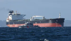 (FILES) A French Navy vessel sails by the Russian oil tanker "Tagor", suspected of flying a false Cameroonian flag and boarded by the French Navy on May 31, 2026, as it arrives in Douarnenez Bay, western France on June 2, 2026. French authorities have released from custody the Russian captain of an oil tanker suspected of belonging to Moscow's sanction-busting "shadow fleet", a prosecutor said on June 4, 2026. He was set free late on June 3, 2026, after around a day in detention "to allow the continuation of extensive and complex judicial investigations", said the public prosecutor of the northwestern city of Brest. (Photo by FRED TANNEAU/AFP)