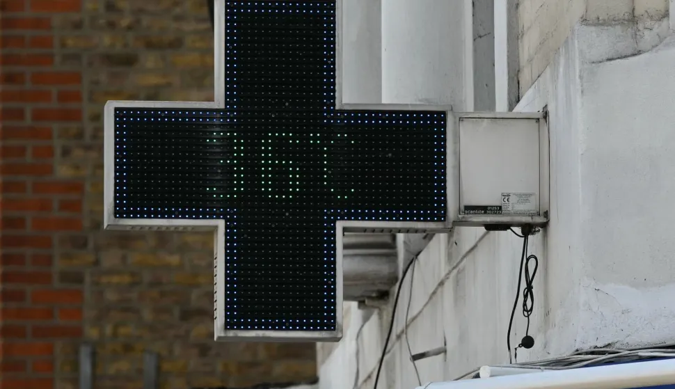 A sign outside a pharmacy displays the 36 degree temperature in west London during a heatwave, in central London on June 24, 2026. The UK recorded its hottest ever June temperature on Wednesday with the mercury rising to 35.7C south of London, breaking the previous record of 35.6C set in 1976. The UK's Met Office weather service said the temperature was recorded in Charlwood, near Gatwick Airport, as Britain experiences a second month in a row of record-breaking heat. (Photo by JUSTIN TALLIS/AFP)