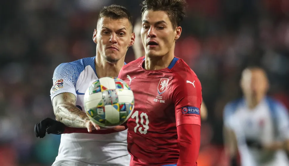 epa07177993 Patrik Schick (R) of Czech Republic in action against Martin Skrtel (L) of Slovakia during the UEFA Nations League soccer match between Czech Republic and Slovakia in Prague, Czech Republic, 19 November 2018. EPA/MARTIN DIVISEK