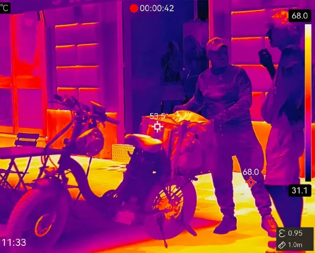 This handout video grab taken and released by Environmental group Greenpeace on June 24, 2026 shows an image taken with a thermal camera measuring temperatures where food delivery riders are working near Termini railway station in Rome during a heatwave. Delivery riders dash around Rome in the hottest hours of the day -- despite being ordered by local authorities not to work between 12:30 pm and 4:00 pm -- as activists walk the streets with a thermal imaging camera to raise awareness of the blistering conditions. Temperatures in the Italian capital are expected to rise to 38C by the weekend. (Photo by Handout/GREENPEACE/AFP)/RESTRICTED TO EDITORIAL USE - MANDATORY CREDIT "AFP PHOTO/GREENPEACE ITALY" - HANDOUT - NO MARKETING NO ADVERTISING CAMPAIGNS - DISTRIBUTED AS A SERVICE TO CLIENTS