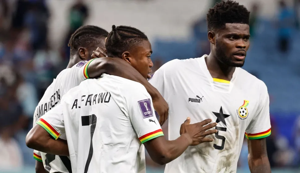 (FILES) Ghana's forward #07 Abdul Fatawu Issahaku and Ghana's midfielder #05 Thomas Partey react at the end of the Qatar 2022 World Cup Group H football match between Ghana and Uruguay at the Al-Janoub Stadium in Al-Wakrah, south of Doha on December 2, 2022. Ghana's player Thomas Partey, who is facing trial in Britain on rape charges, has been denied a visa to enter Canada to play in the World Cup, FIFA said on on June 12, 2026. The association football said it was "not involved in the immigration processes of host countries, including the adjudication of visas". (Photo by Khaled DESOUKI/AFP)
