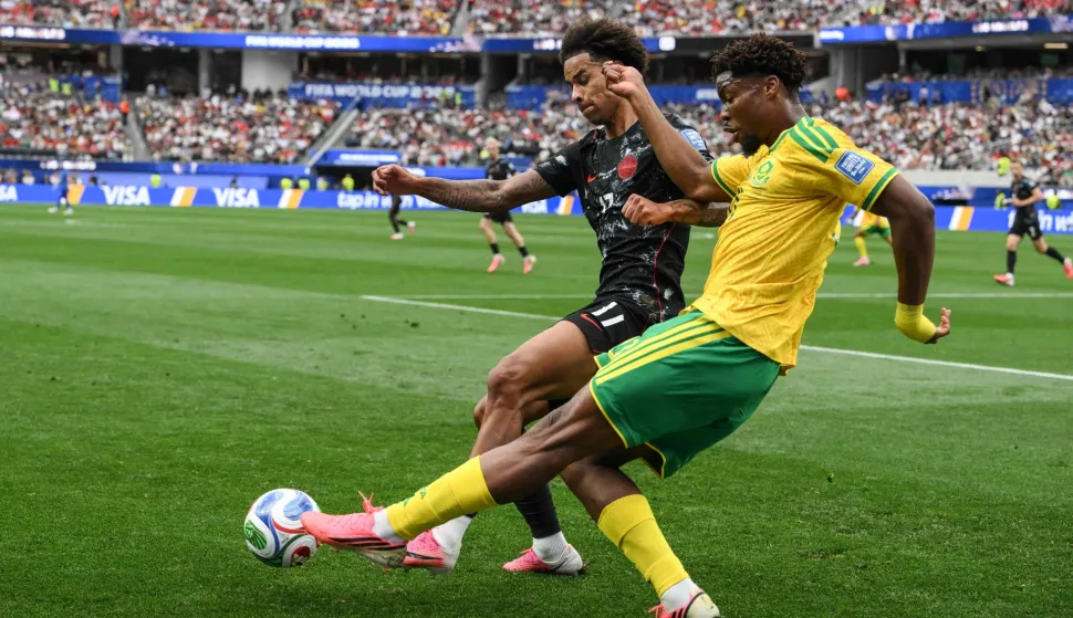 Canada's midfielder #17 Tajon Buchanan and South Africa's defender #21 Ime Okon (R) fight for the ball during the 2026 World Cup round of 32 football match between South Africa and Canada at the Los Angeles Stadium in Inglewood on June 28, 2026. (Photo by Patrick T. Fallon/AFP)