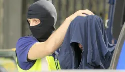 epa06040478 Spanish National policemen escort a suspected Moroccan jihadist (R) after his arrest in Madrid, Spain, 21 June 2017. Spanish police have arrested three Moroccan men, including a 32-year-old alleged member of the so-called Islamic State (IS or ISIS, ISIL) considered a 'serious threat for the security in Spain,' and whose profile matches with the terrorists involved in the recent attacks carried out in United Kingdom and France, Spanish Home Affairs Ministry confirmed. EPA/VICTOR LERENA
